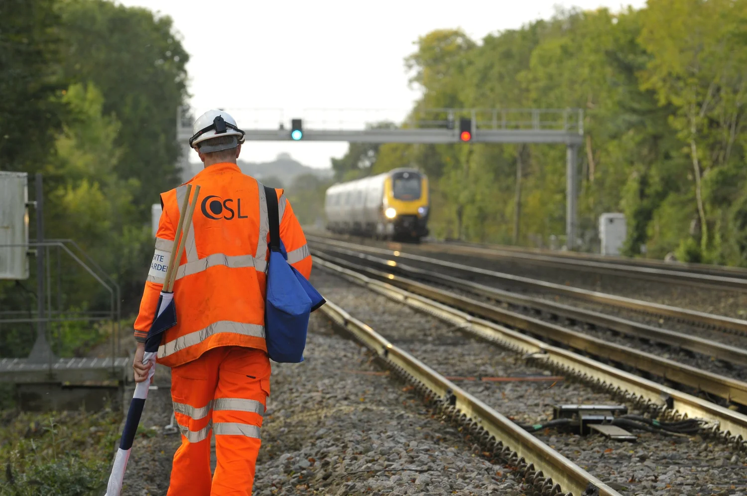 OSL engineer walking the track as a train approaches