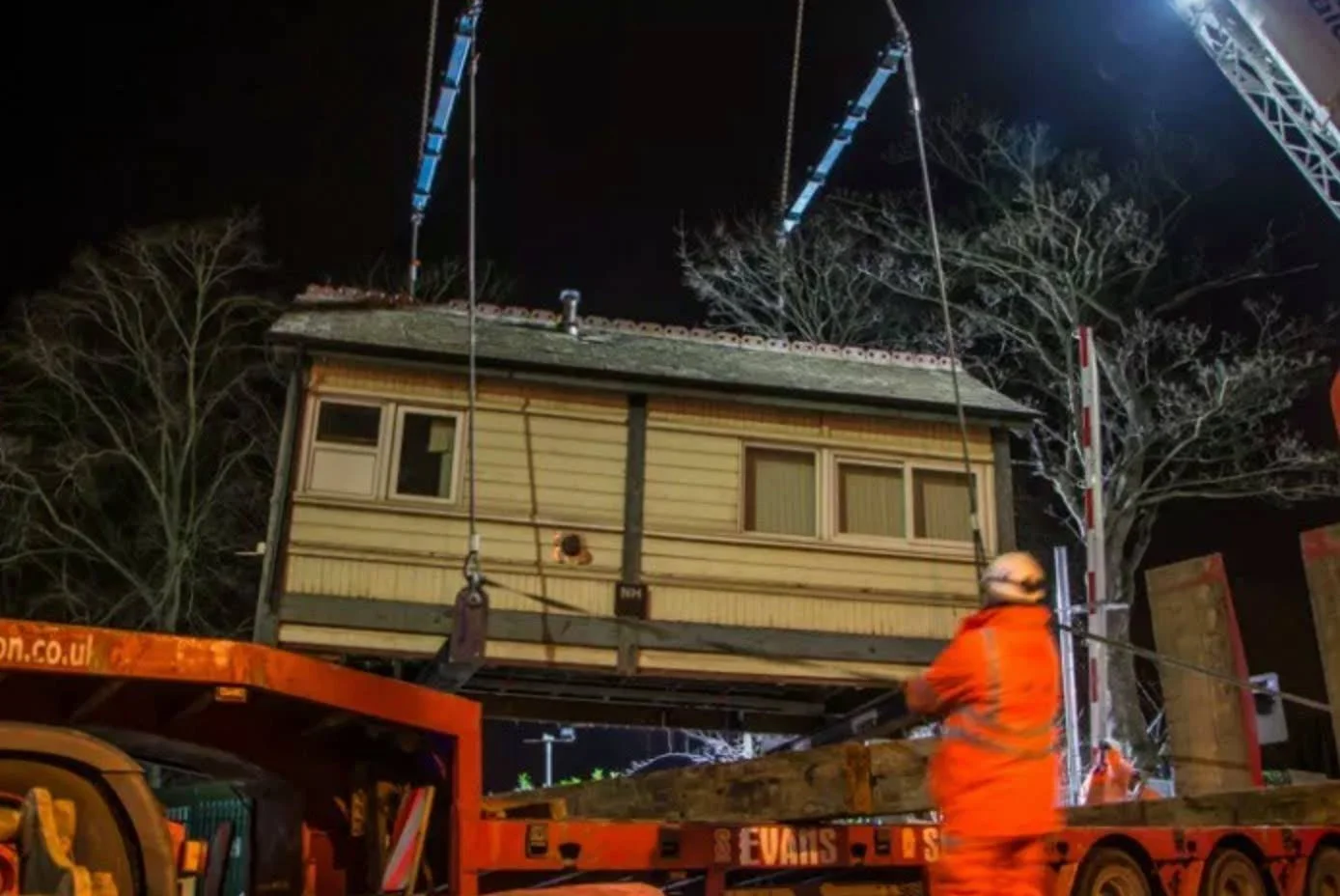 Signal box being lifted into position at night