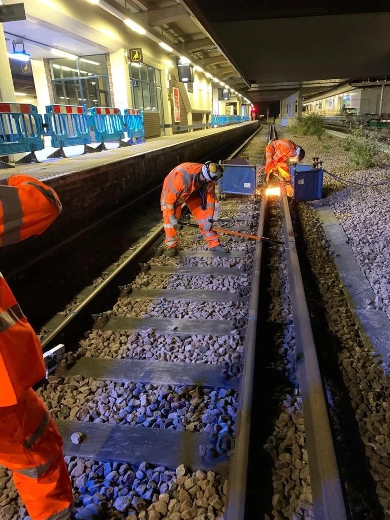 OSL engineers working beside a station platform