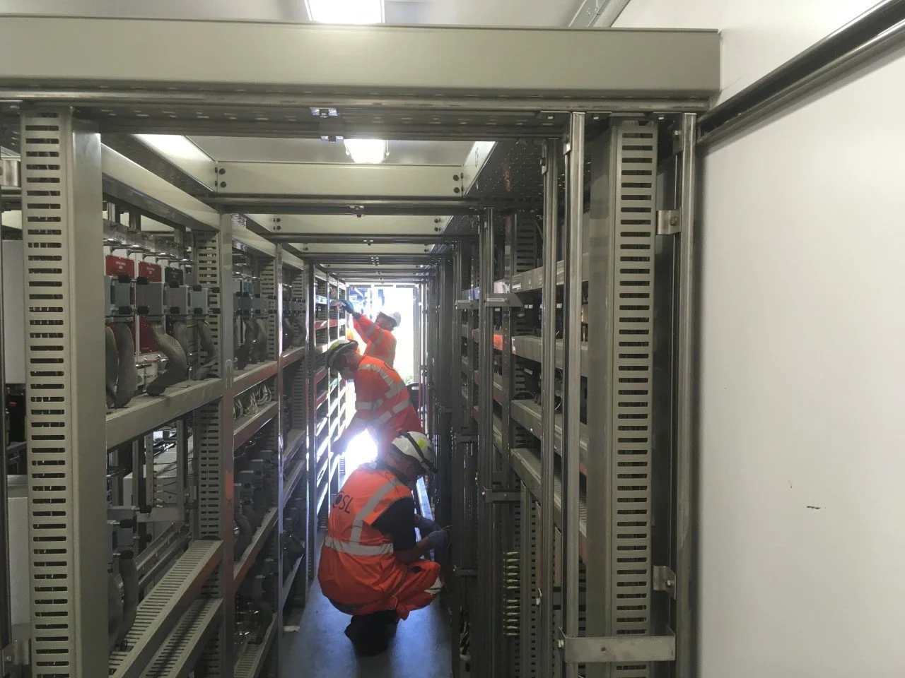 OSL engineers working in an equipment room