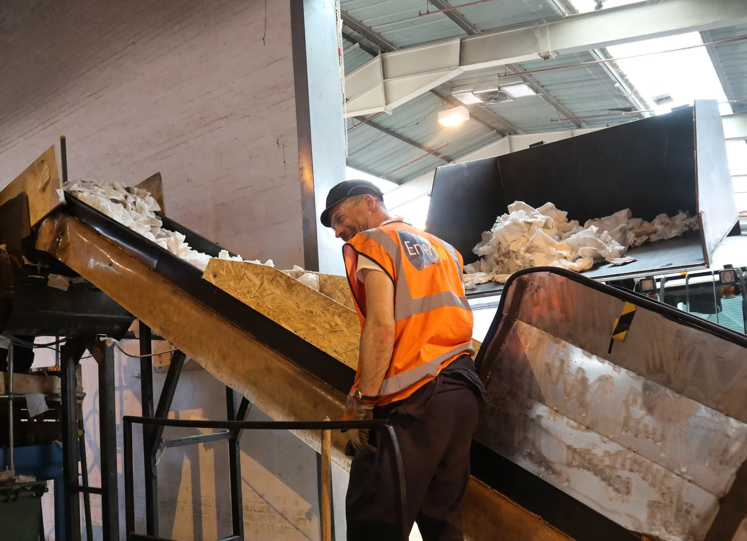 OSL engineer working at a waste processing conveyor